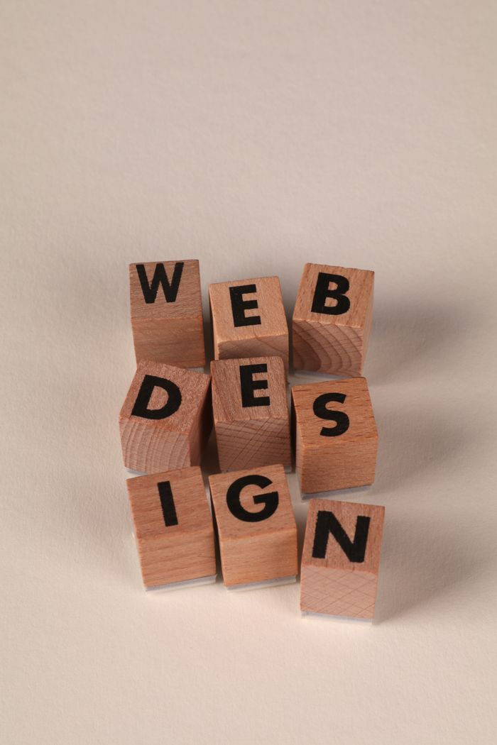 project-01-c Wooden blocks arranged to spell Web Design. Ideal for creative, digital content themes.